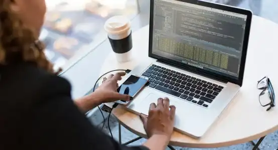 A women coding at a laptop